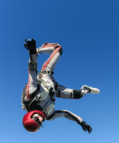 Solo skydiver above Patagonia – soaring over snow-capped peaks and vast wilderness during an epic adventure
