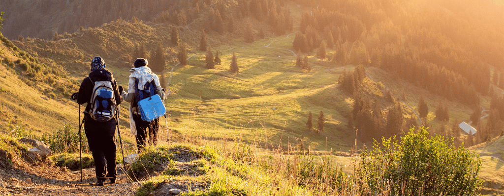 A couple hiking together along the Inca Trail in Peru, surrounded by ancient stone paths, lush greenery, and mountain views en route to Machu Picchu