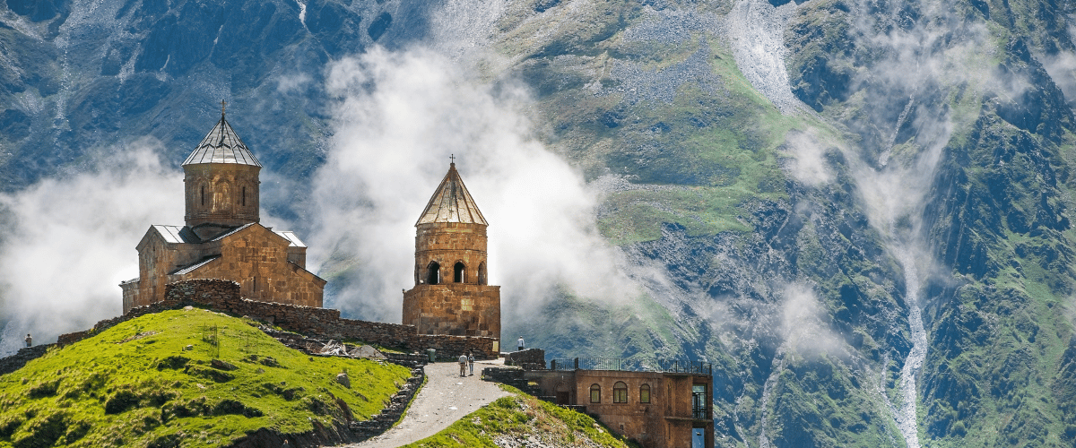 Scenic mountain views of Gergeti Trinity Church, ideal for relaxation and spiritual wellness in Georgia.