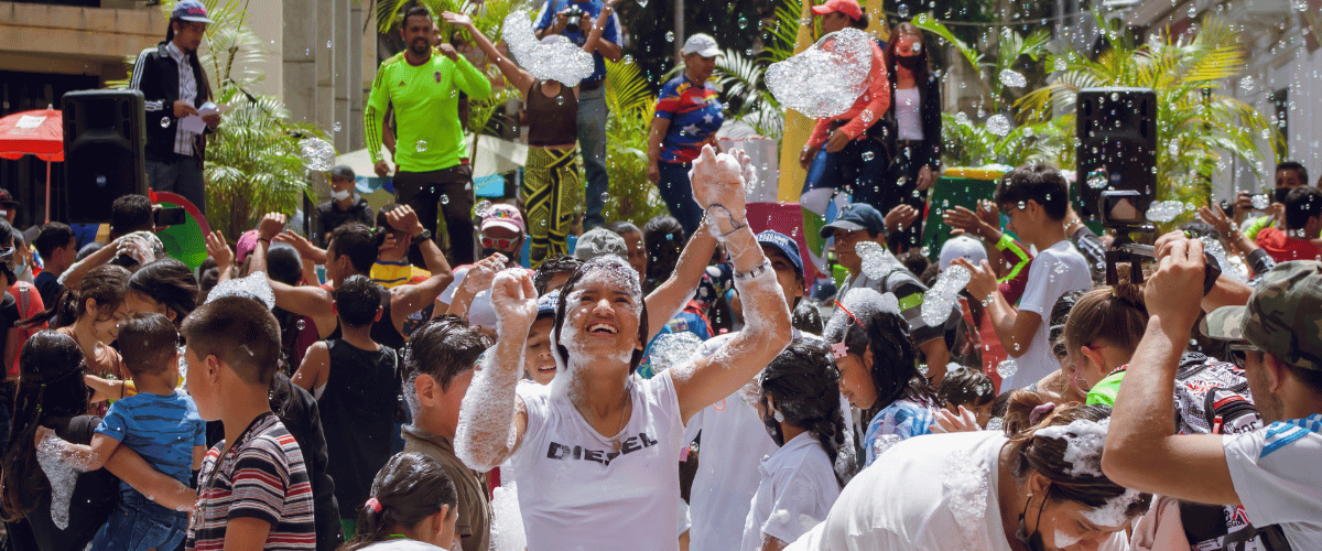 Crowd of people celebrating at a foam party festival in Georgia, highlighting local culture and travel experiences.