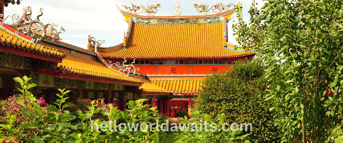 The ornate golden-yellow roofs of the Lian Shan Shuang Lin Monastery in Toa Payoh, Singapore, featuring traditional Chinese architecture and dragon carvings.