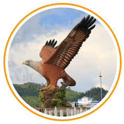 Vibrant heritage buildings and colorful mural art lining the Melaka River under a blue sky in Malaysia.