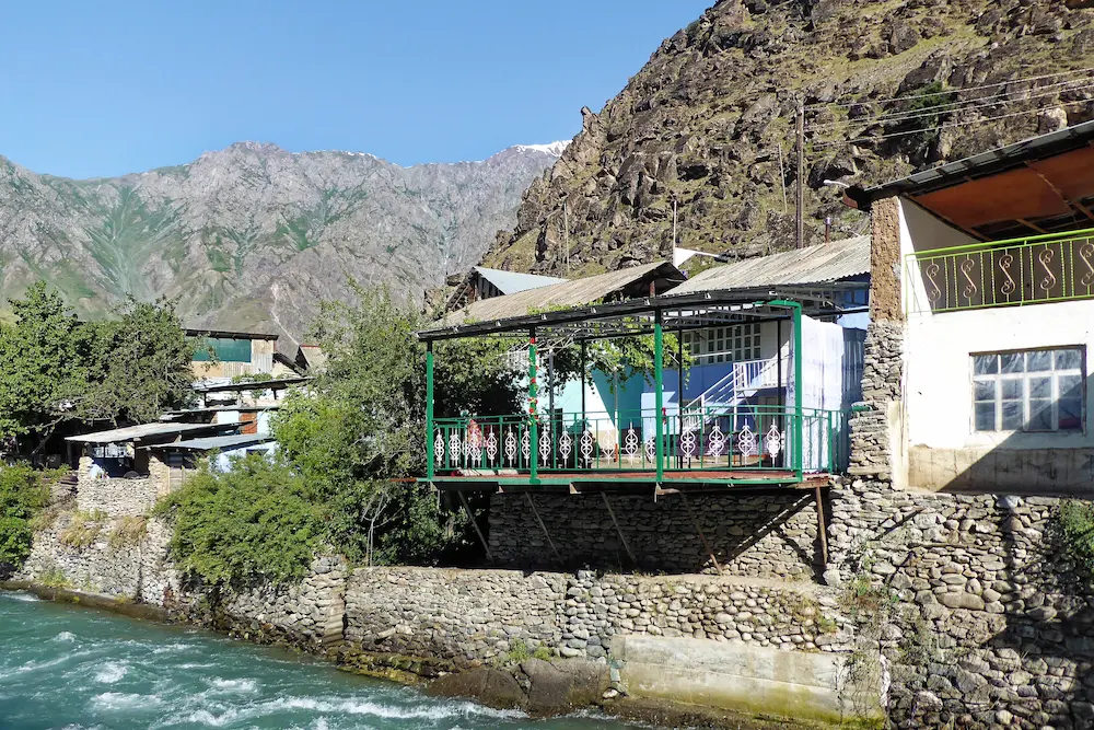 Stone houses along a rushing river in Kalaikhum village, Tajikistan.
